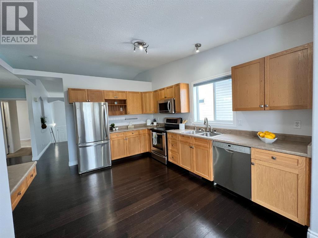 Grande Prairie Mission Heights family home — kitchen with stainless appliances