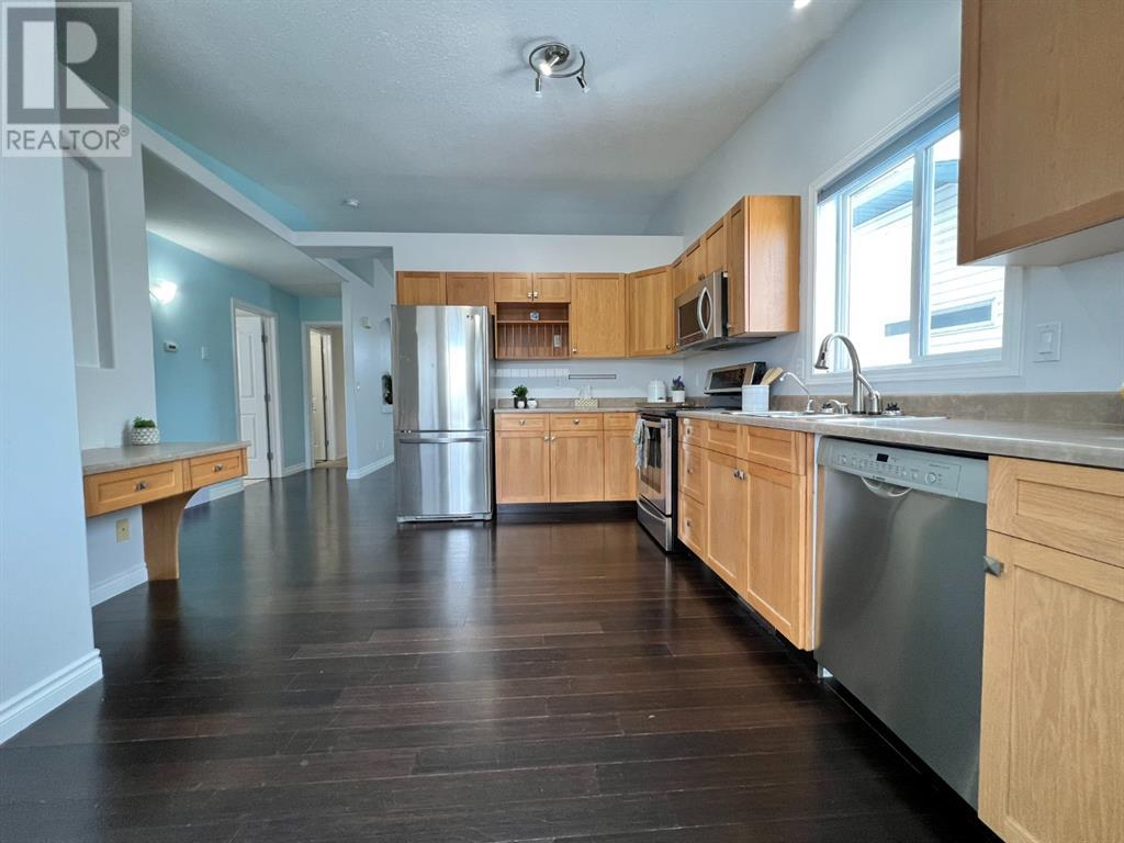 Grande Prairie Mission Heights family home — kitchen open to hallway