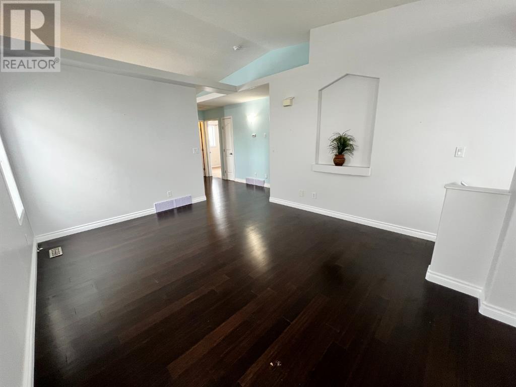 Grande Prairie Mission Heights family home — living room with hardwood floors